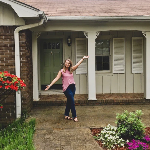 Happy lady standing outside home